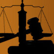 A silhouette of a gavel and scale.