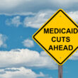 A yellow sign stating "Medicaid cuts ahead"